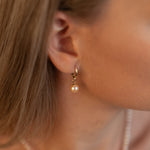 Cercei lungi cu perle naturale de cultură roz, purtați