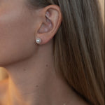 Cercei stud cu perle naturale de cultură albe, purtați